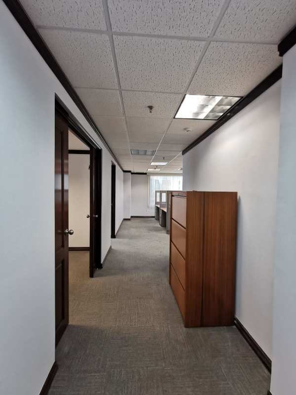 Private executive office furnished with large window overlooking city skyline in Panama World Trade Center