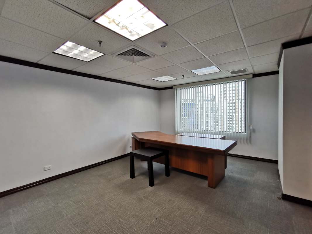 Corner office view with floor-to-ceiling window and panoramic cityscape in Marbella World Trade Center