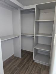 Modern minimalist kitchen with grey cabinets, black backsplash at PH Centriqo Panama Pacifico