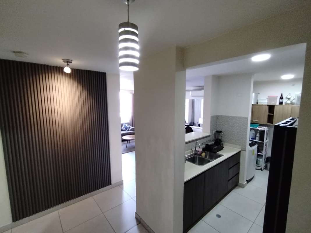 Furnished open kitchen and living room in PH Vista Horizonte with pendant lights Panama City