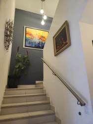 Interior staircase with ceramic tiles decorative wall art and pendant lighting Woodlands Panama