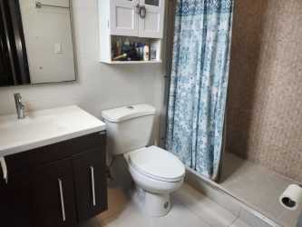 Modern bathroom with vanity mirror and walk-in shower Woodlands Panama Pacifico