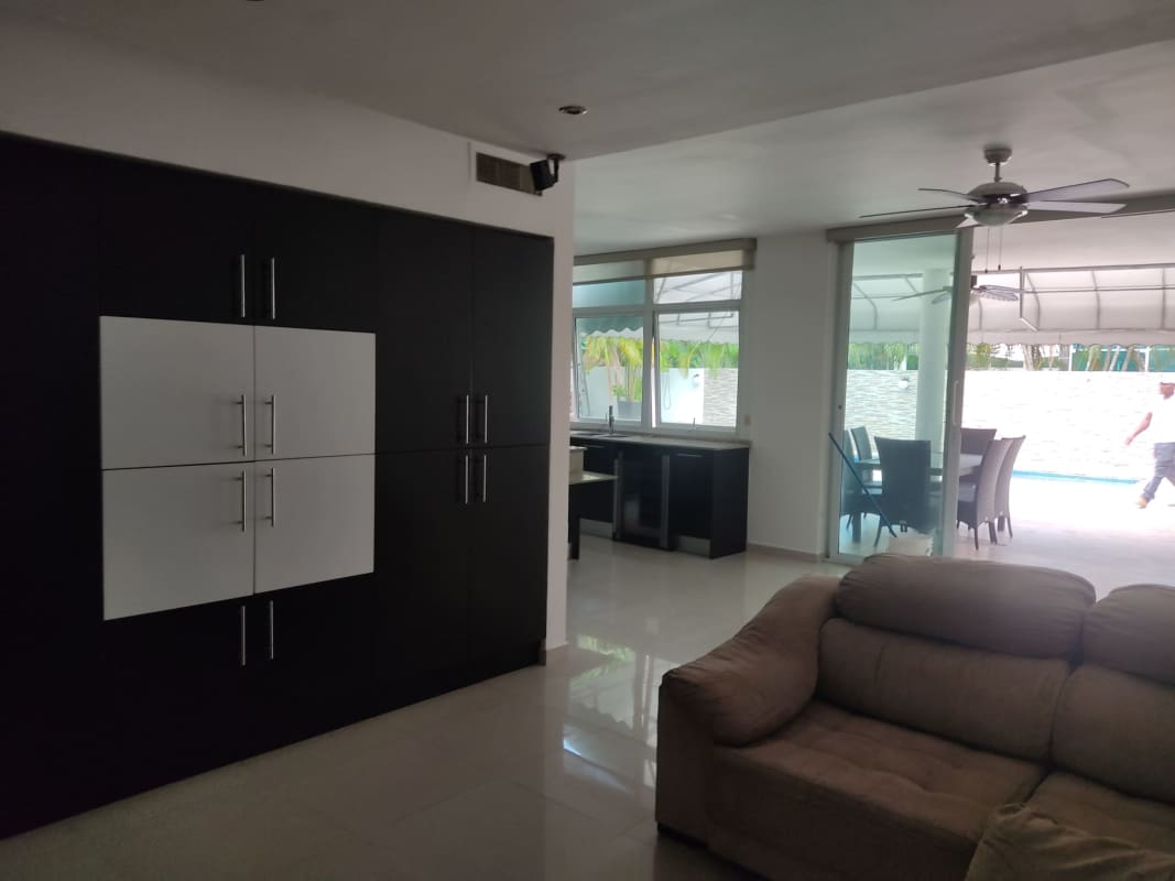 Sleek open kitchen with breakfast island, dark cabinets and stainless appliances Costa Sur Panama