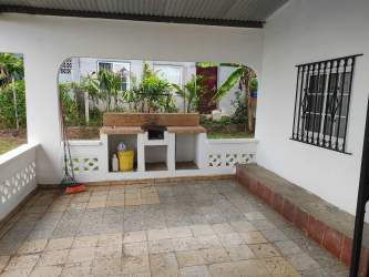 Spacious covered terrace with view of backyard garden Barriada El Maestro Panama