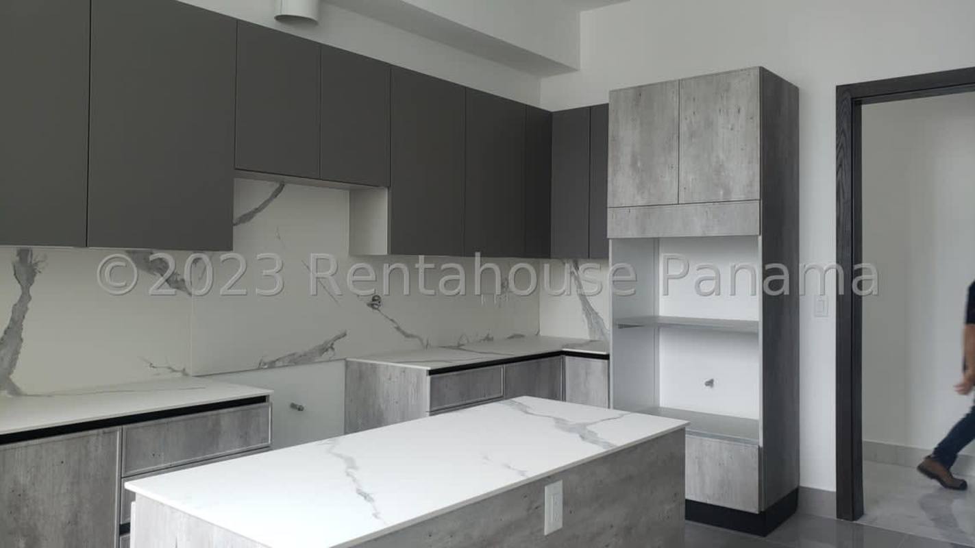 Gourmet kitchen with marble finishes and large window overlooking Panama skyline PH Rivage Punta Paitilla
