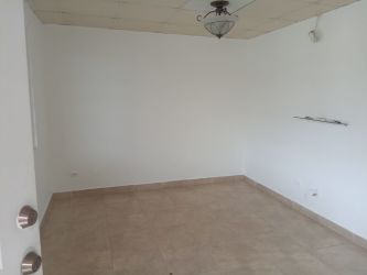 Empty living room area with white walls ceramic tile floor San Cristobal house Panama