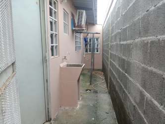 Side passage with outdoor sink and AC units house in Colón