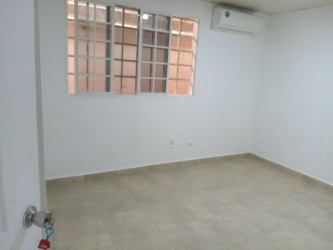 Minimalist bedroom with tiled floors and window Los 4 Altos Colón Panama