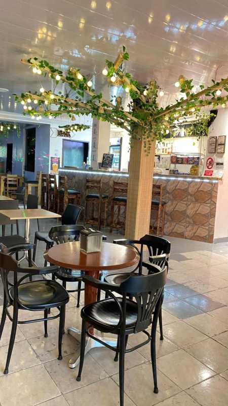 Cafe interior with colorful mural and eclectic seating in Casco Viejo commercial space for rent