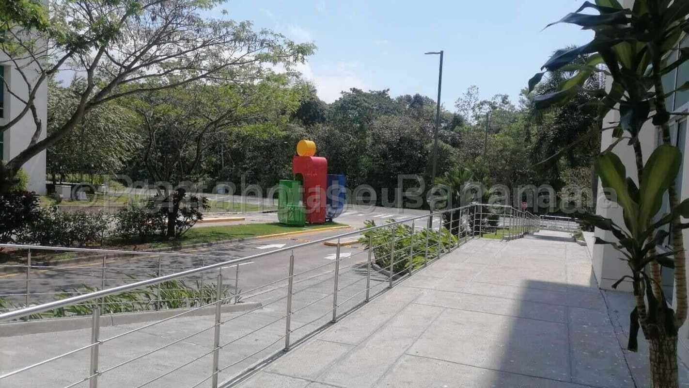 Modern landscaped walkway with trees and colorful sculpture at PanAmerica Corporate Center Panama