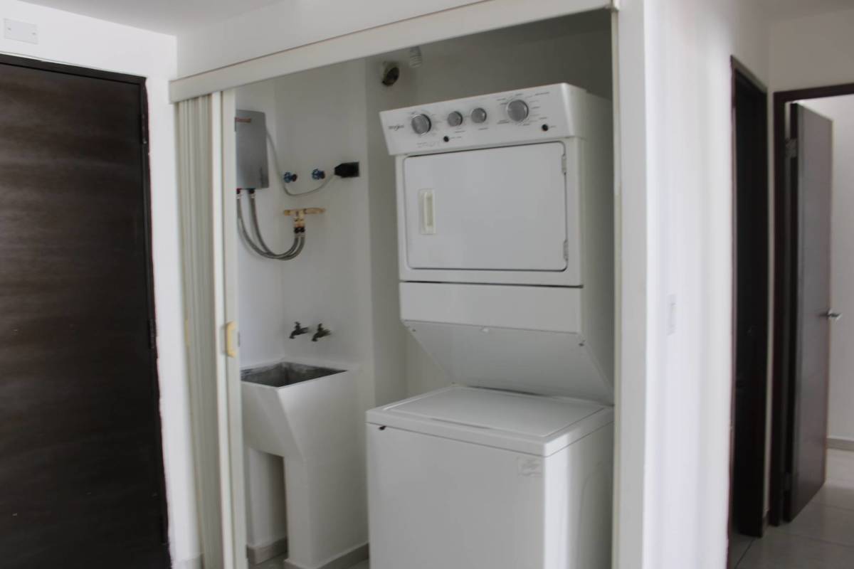 Compact laundry area with washer dryer inside apartment PH Bay View Panama