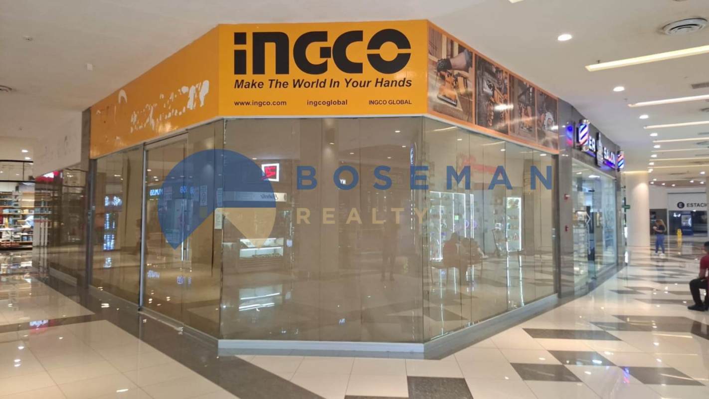 Vacant commercial space inside active El Dorado shopping mall with glass frontage