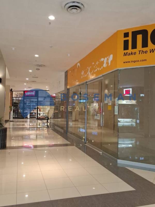 Interior view of empty shop space inside El Dorado shopping mall Panama City with glass storefront