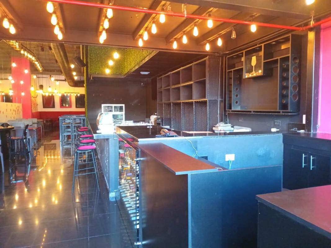 Bar seating area with pendant lights, glass shelving PH San Francisco Plaza Panama City