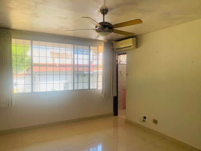 Bright bedroom with ceiling fan, AC, large window and tiled floors in Betania house for sale