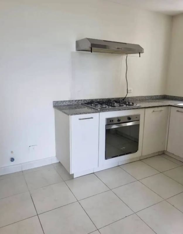 Kitchen with granite countertop, built-in oven and stove in Torres de Cantabria Panama City
