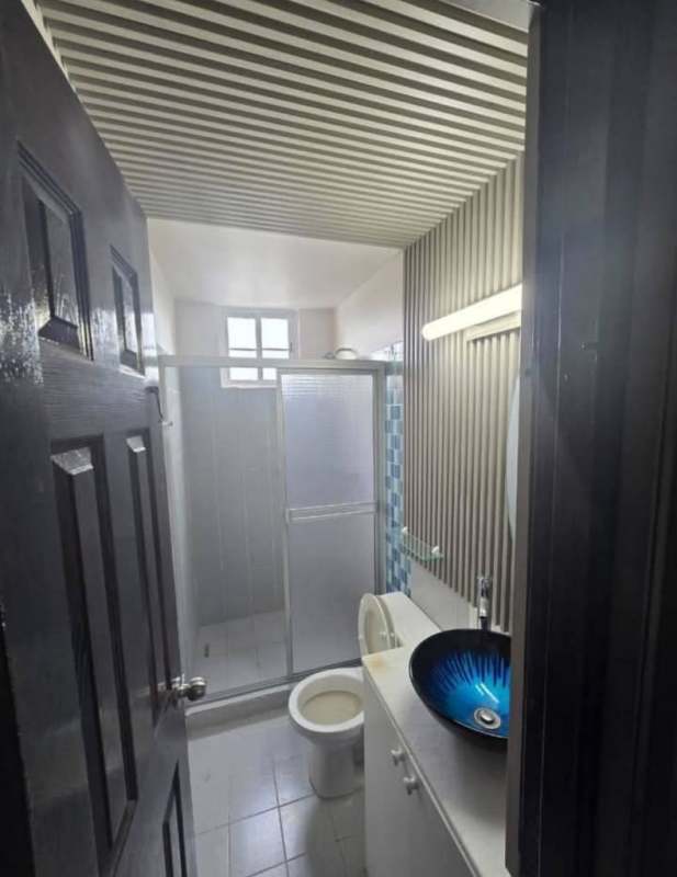 Modern bathroom blue vessel sink enclosed shower striped ceiling Mystic Tower Panama