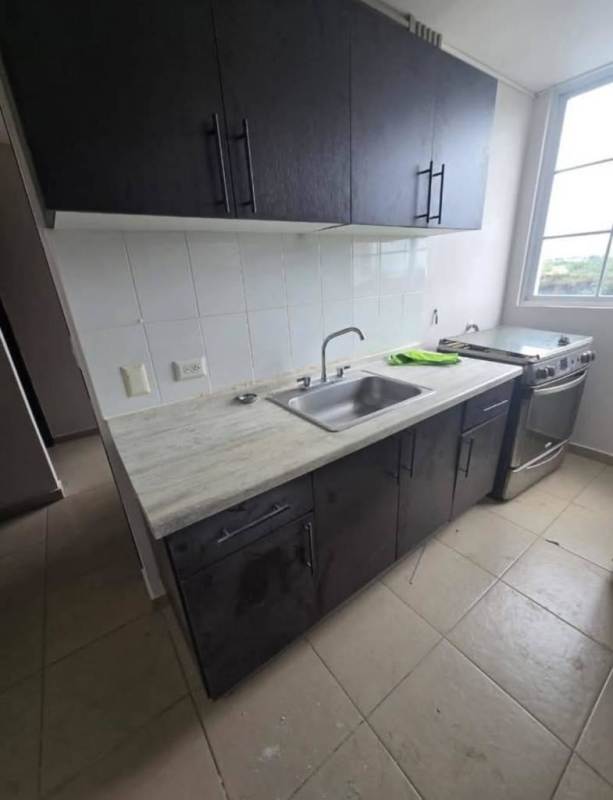 Compact kitchen with stainless steel sink gas stove dark cabinets Mystic Tower Panama