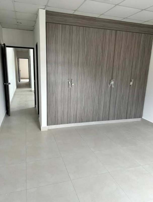 Small powder room with sink and tiled walls under sloped ceiling in duplex house Betania Panama