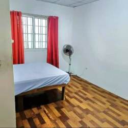 Bedroom with parquet flooring, window with bars, red curtains in Tinajas Dolega country house Panama