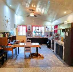 Sunlit backyard with tropical plants, wood fence at country house in Tinajas Dolega Panama