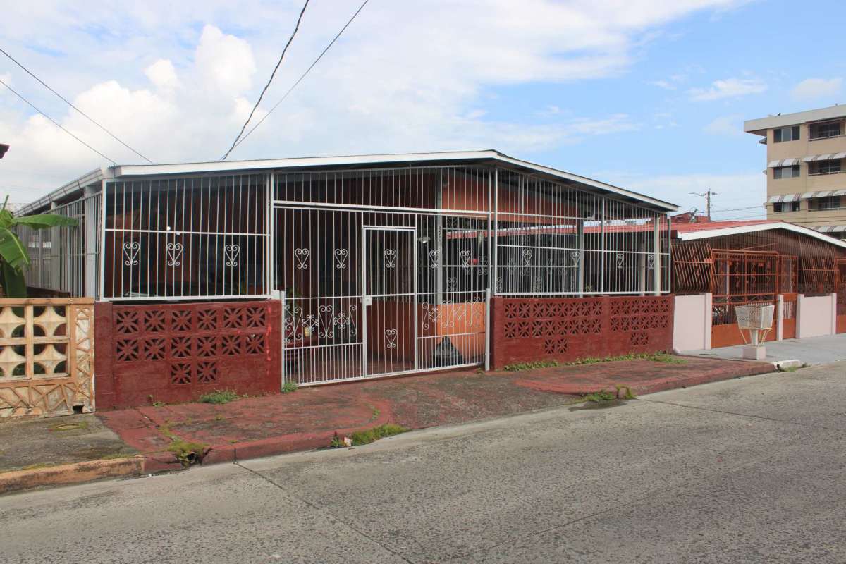 Gated entrance with metal bars securing patio of single-story house Pueblo Nuevo