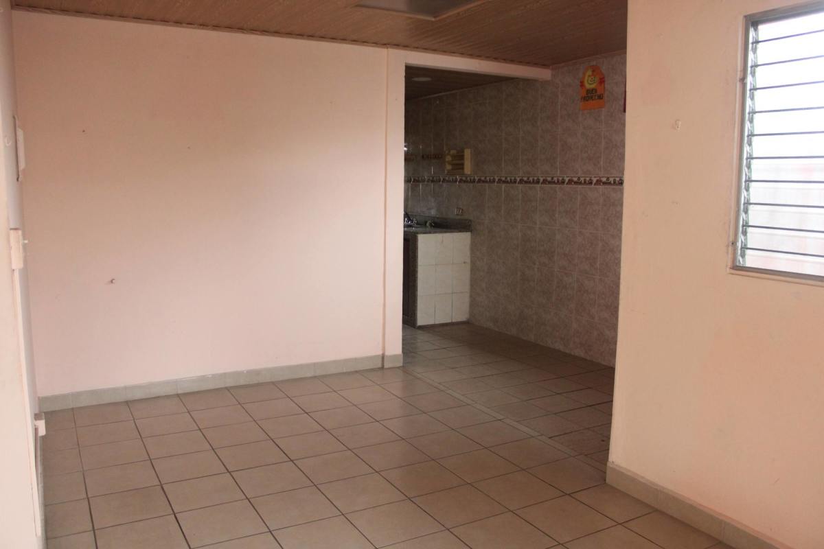 Traditional galley kitchen with tile backsplash and granite counter Pueblo Nuevo house