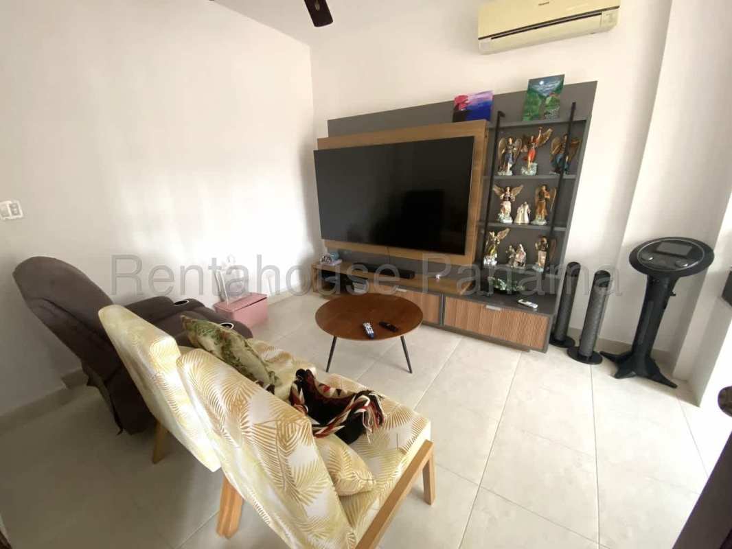 Backyard with covered BBQ terrace, tiled floor, garden plants at Villa Valencia Costa Sur Panama