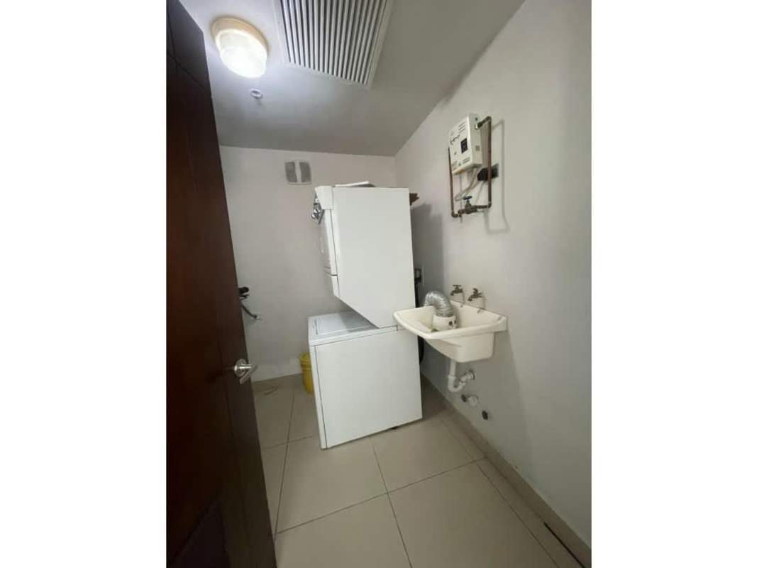 In-unit laundry with stacked washer/dryer and sink in Ocean Park Panama City