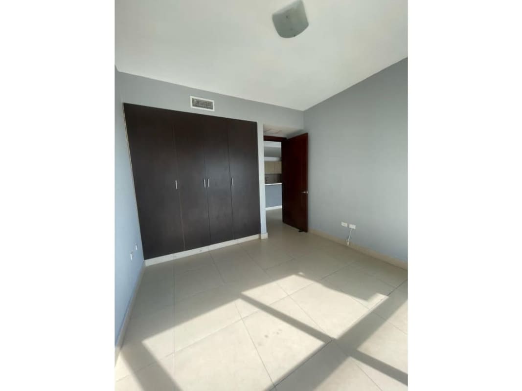 Modern bedroom with built-in wardrobe and window view Ocean Park rental apartment