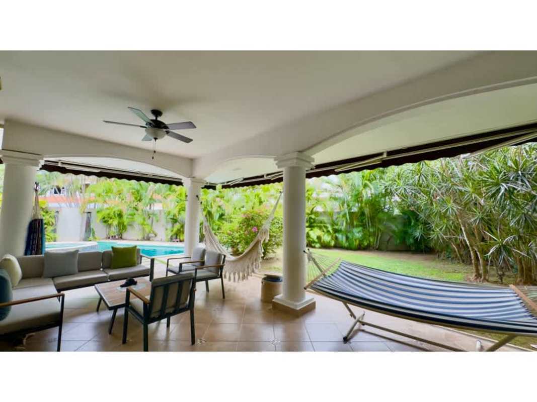 Covered outdoor kitchen terrace with BBQ and dining in luxury Costa del Este house Panama