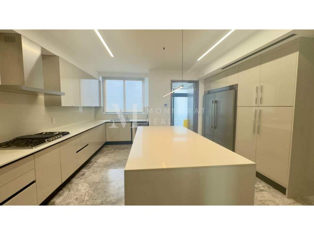 Spacious modern kitchen with marble island and city view at PH Empire Santa María Panama
