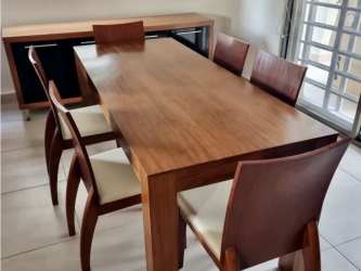 Bright dining room with wooden table and window inside single family home Palmia Panama Pacifico