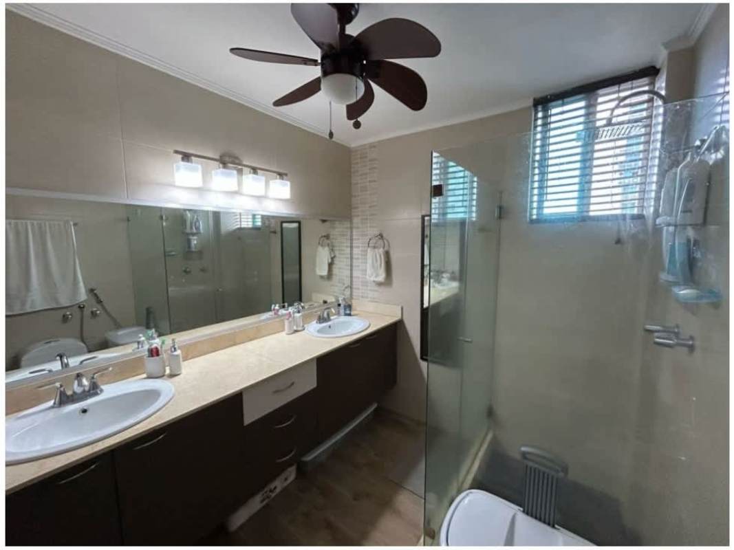 Elegant tiled bathroom with glass shower and vanity in PH 7400 EAST Panama