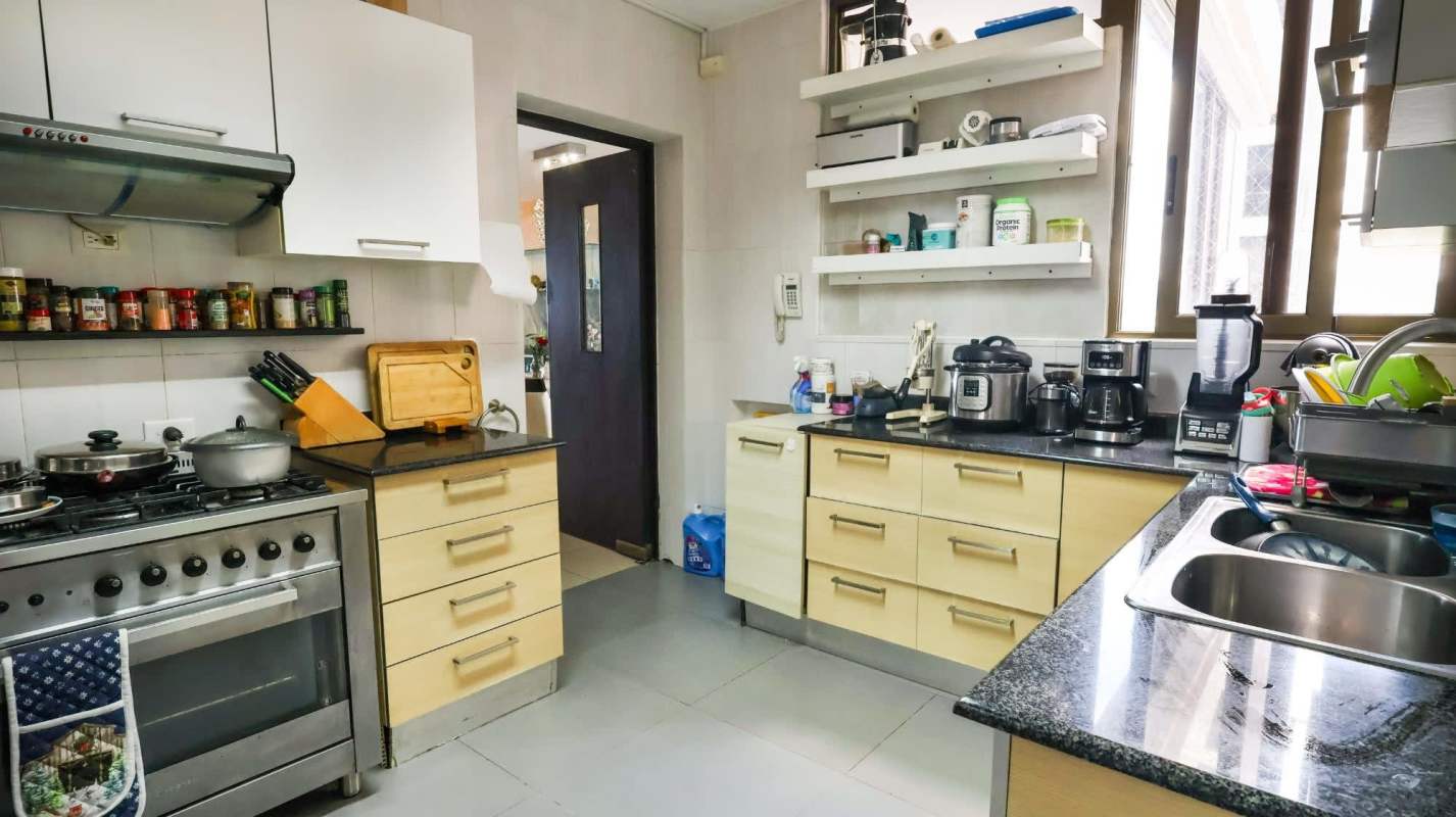 Modern balcony with wicker furniture, safety mesh, ocean view in Panama City condo