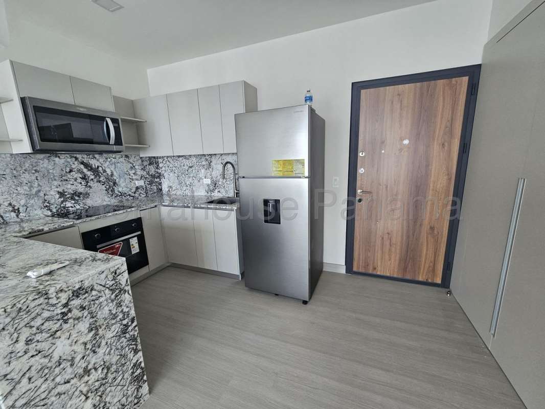 Master bedroom in PH Arcadia with ocean-facing window in Costa del Este, Panama.