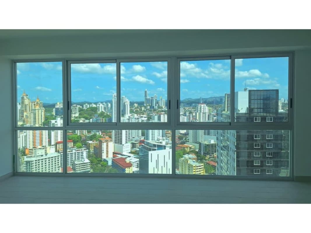Well-equipped laundry room with stacked washer and dryer PH Urbana Panama City
