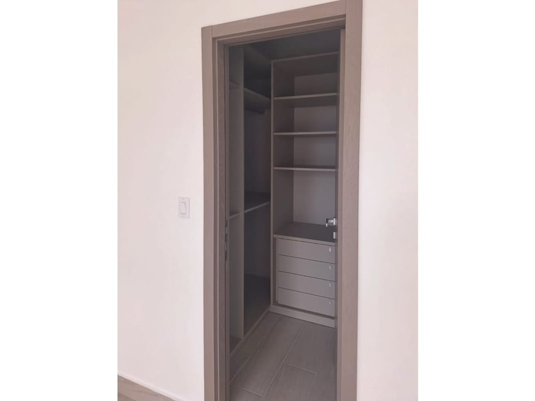 Spacious walk-in closet with organized shelves and cabinets in PH Urbana Obarrio