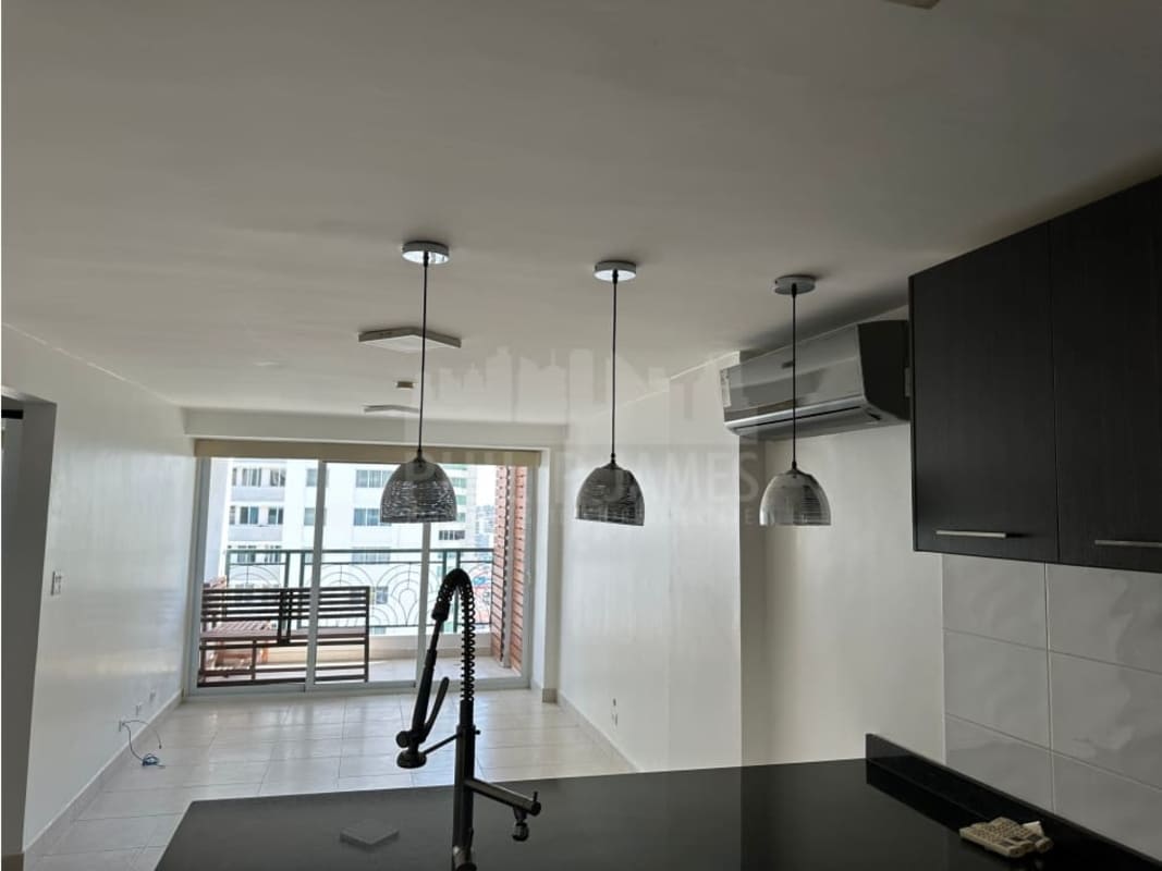 Modern kitchen with granite countertops, pendant lighting and dark wood cabinetry at PH Belview Tower in Edison Park Panama City