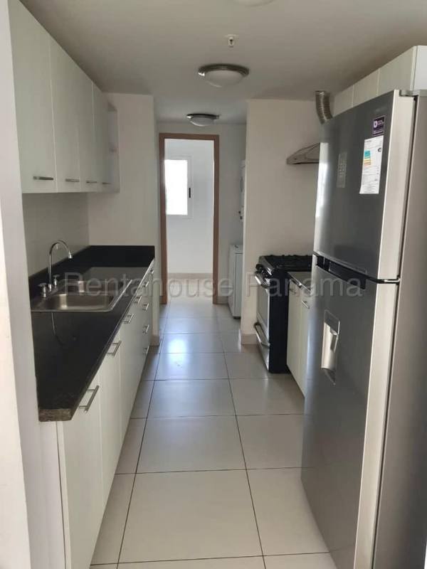 Modern galley kitchen with granite counters and appliances in PH Tee One Panama