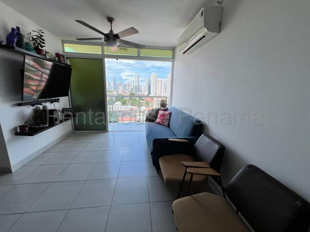 Living room with large windows and urban skyline views at Metropolitan Park Panama