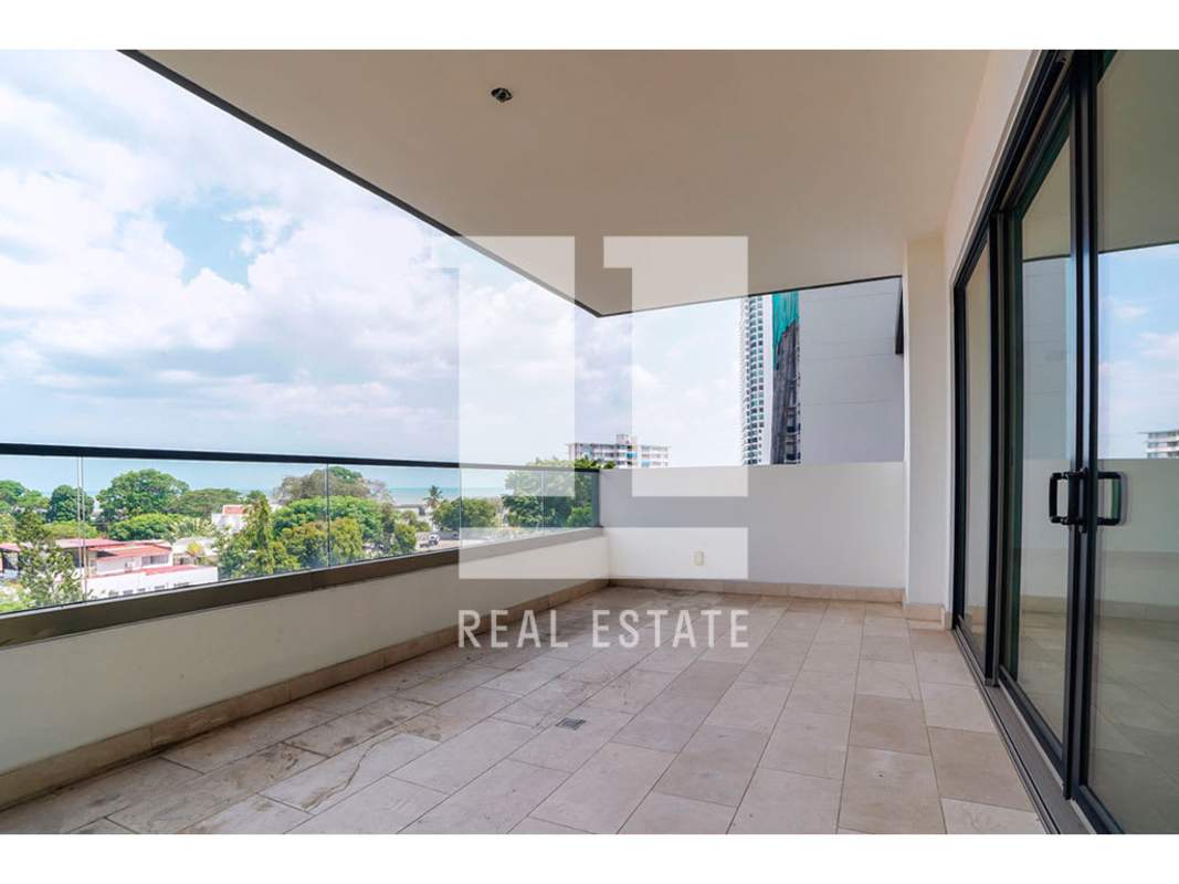 Bright bedroom with city view window and walk-in closet in PH Caleta Panama City