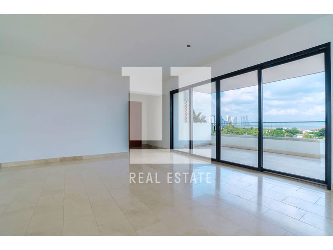 Modern minimalist kitchen with black countertops, wood cabinets, and large window overlooking city skyline in PH Caleta Coco del Mar