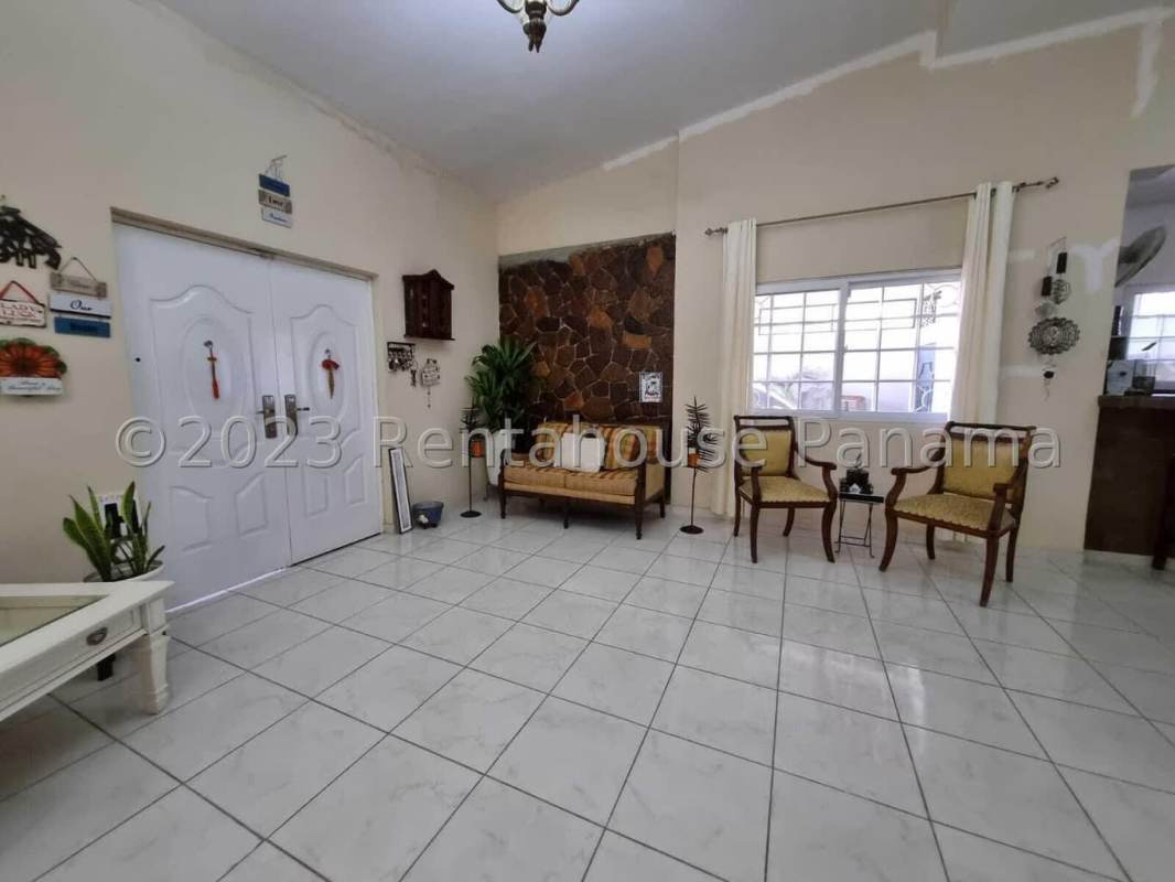 Contemporary kitchen with granite counters, large windows, stainless appliances in Altos del Golf house Panama