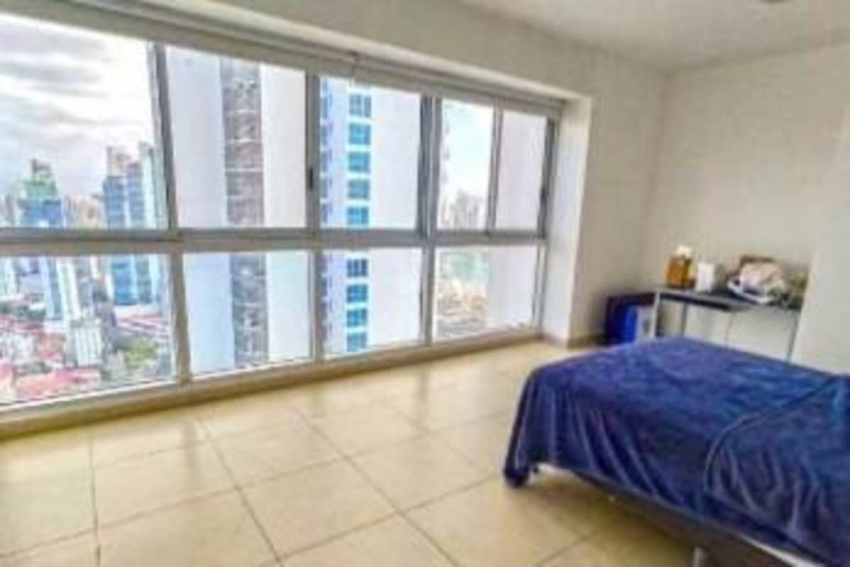Modern bathroom featuring glass shower, double sinks and panoramic city and ocean view in PH Rivage Panama