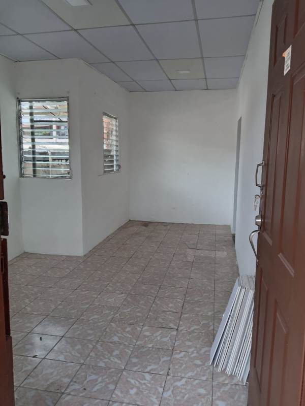 Empty room with two windows secured with bars, tiled floor, and white walls Victoriano Lorenzo Panama