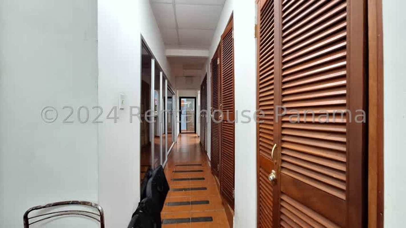 Interior hallway with wooden doors glass partitions commercial office space San Francisco Panama