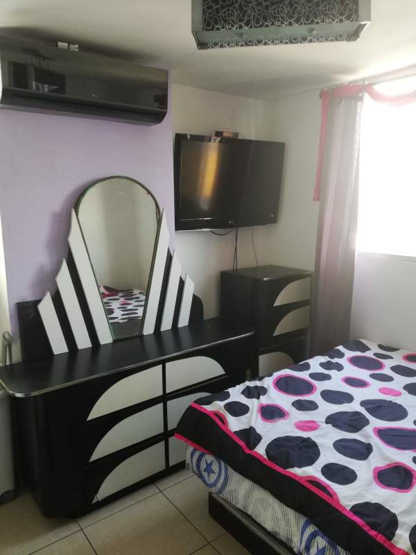 Contemporary bedroom with AC, mounted TV, window, and modern furniture in PH Bella Vista Garden Panama