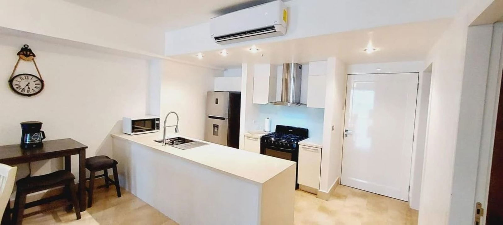 Gourmet marble countertop kitchen with island and modern appliances at PH YOO Panama Bella Vista