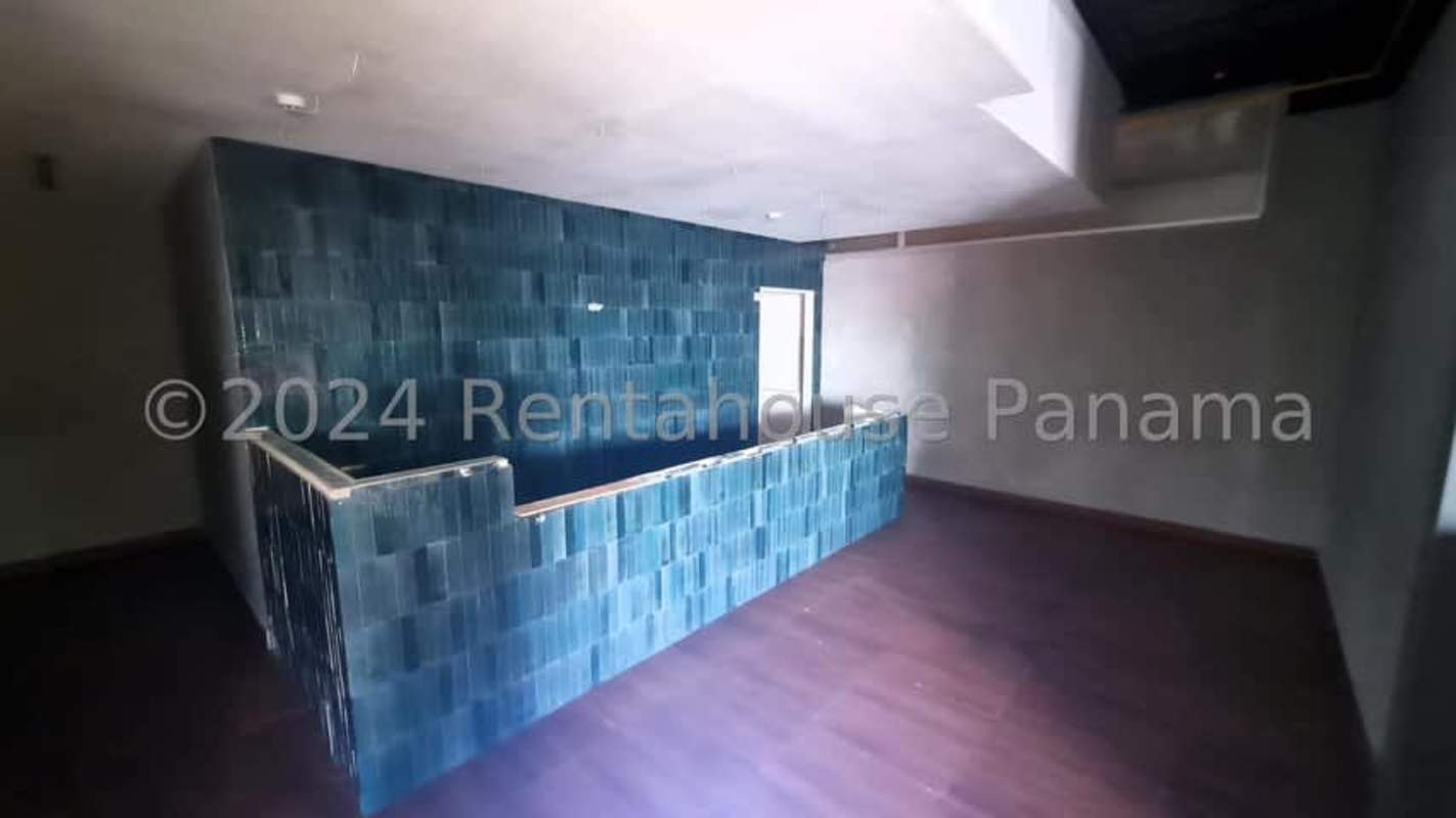 Second floor interior space with railing, office area, murals in commercial space San Francisco Panama